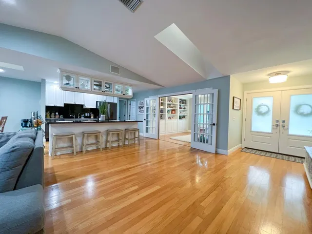 a view of a kitchen with kitchen island and living room