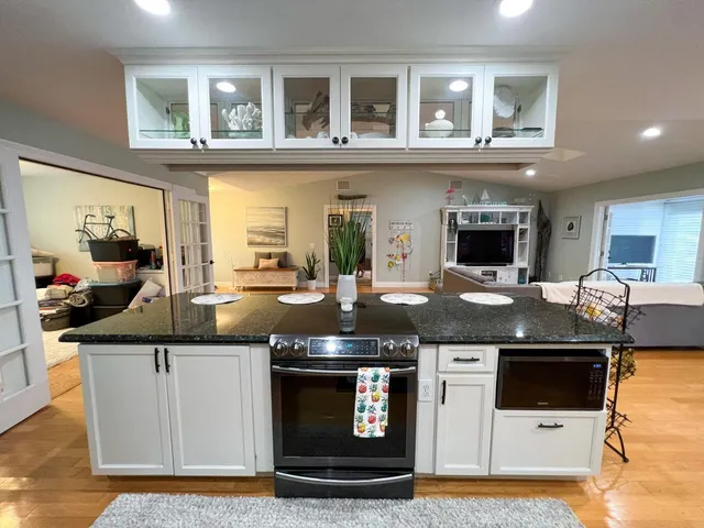 a kitchen with stainless steel appliances granite countertop a stove and a sink