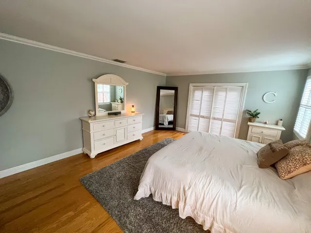 a spacious bedroom with a large bed and a dresser