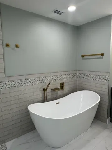 a white bath tub sitting in a bathroom