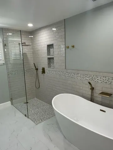 a spacious bathroom with a bathtub and shower