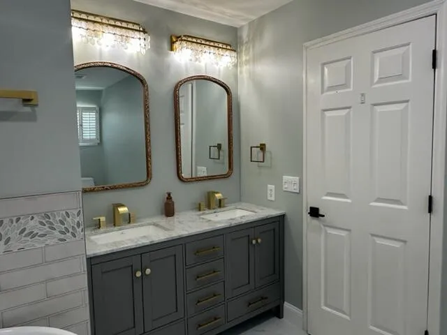 a bathroom with a double vanity sink and mirror