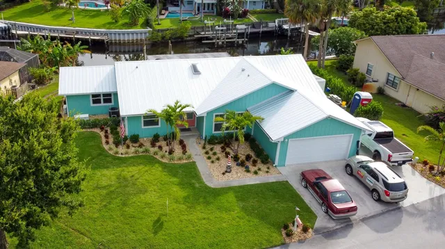 an aerial view of a house with garden space and a patio