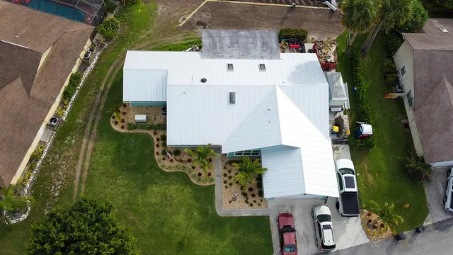 an aerial view of a house with a yard