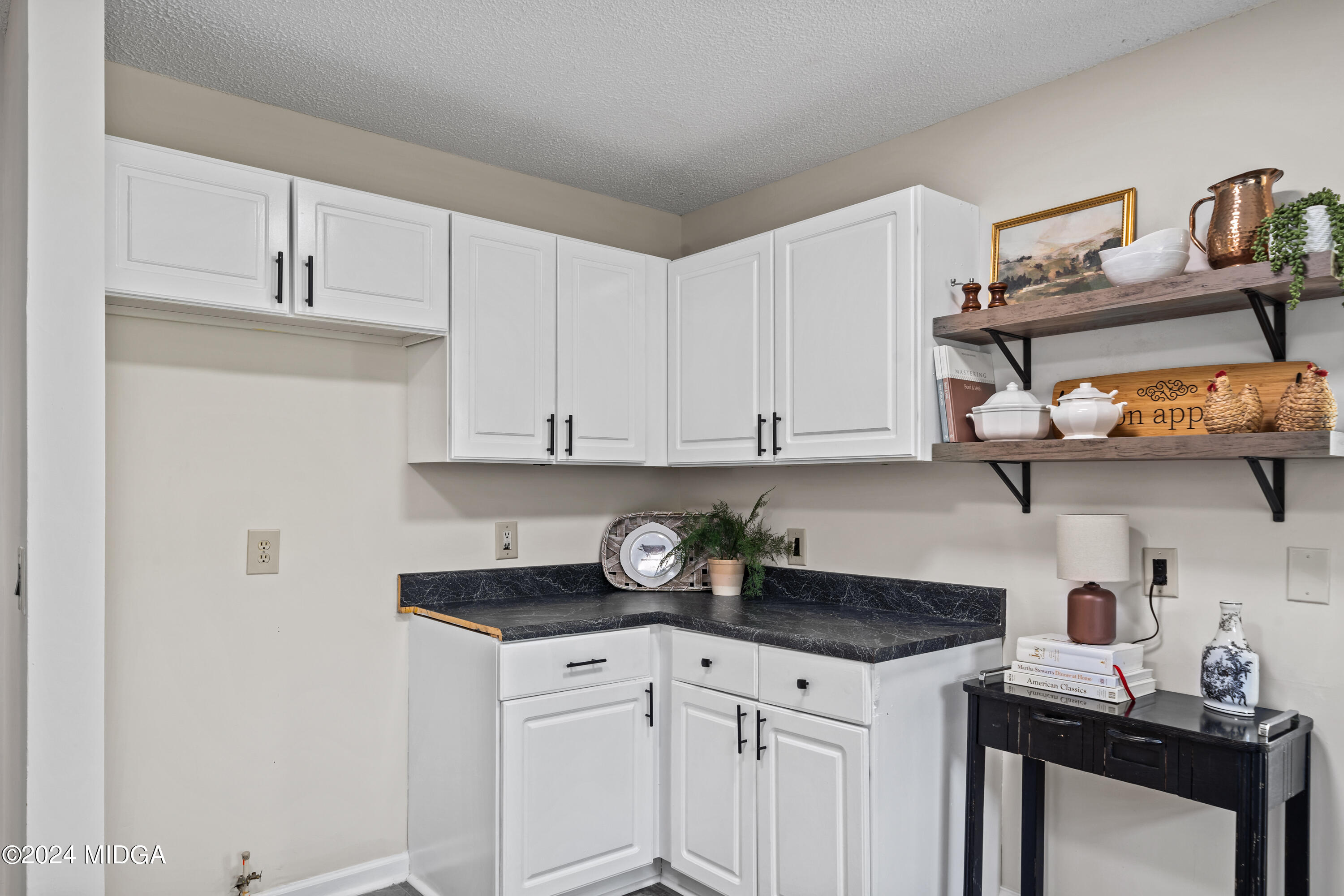 246 Langston Road Perry, GA 31069 - Photo 17 of 37 a kitchen with stainless steel appliances granite countertop a sink a stove and white cabinets