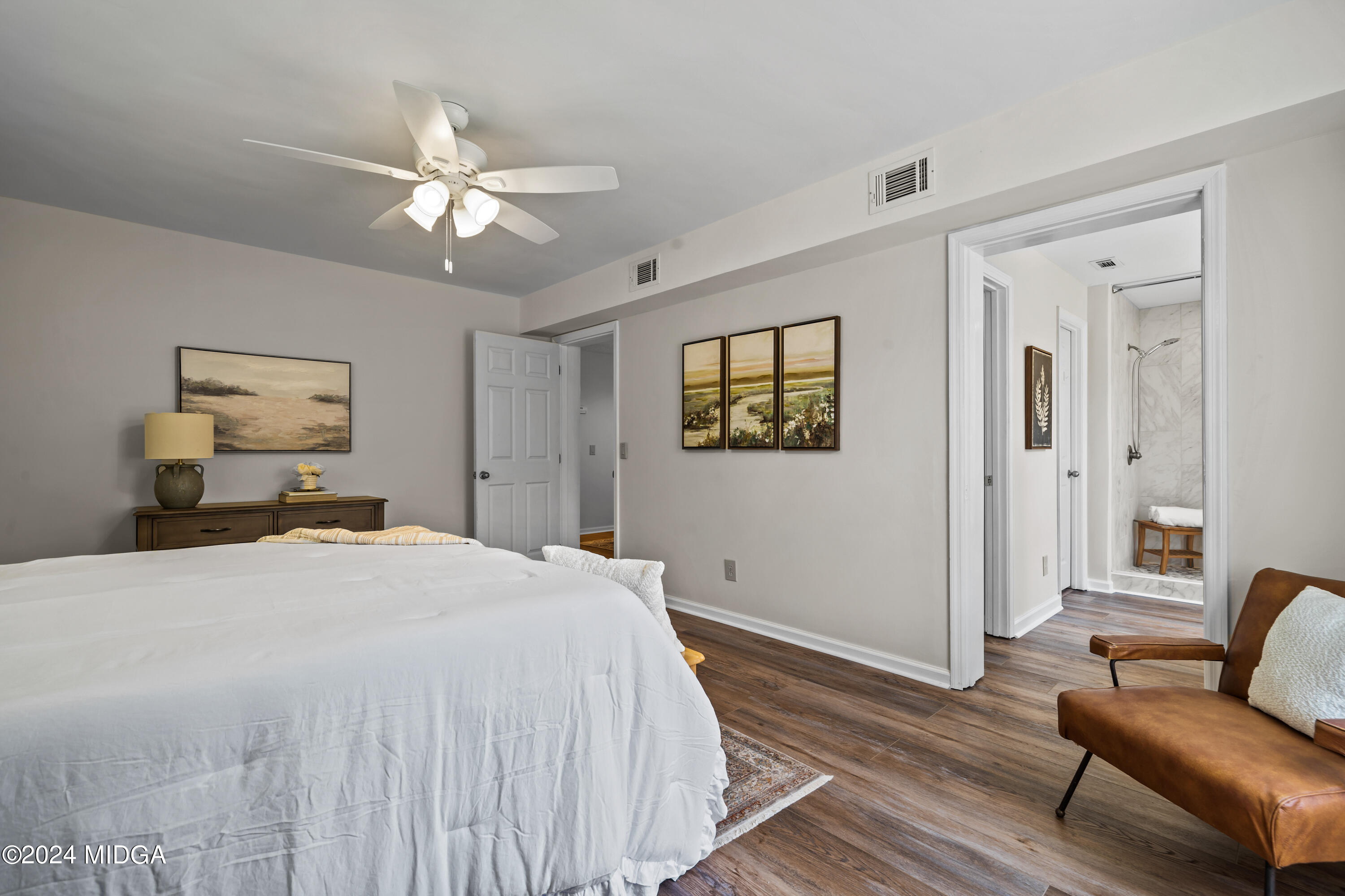 246 Langston Road Perry, GA 31069 - Photo 24 of 37 a spacious bedroom with a bed and wooden floor