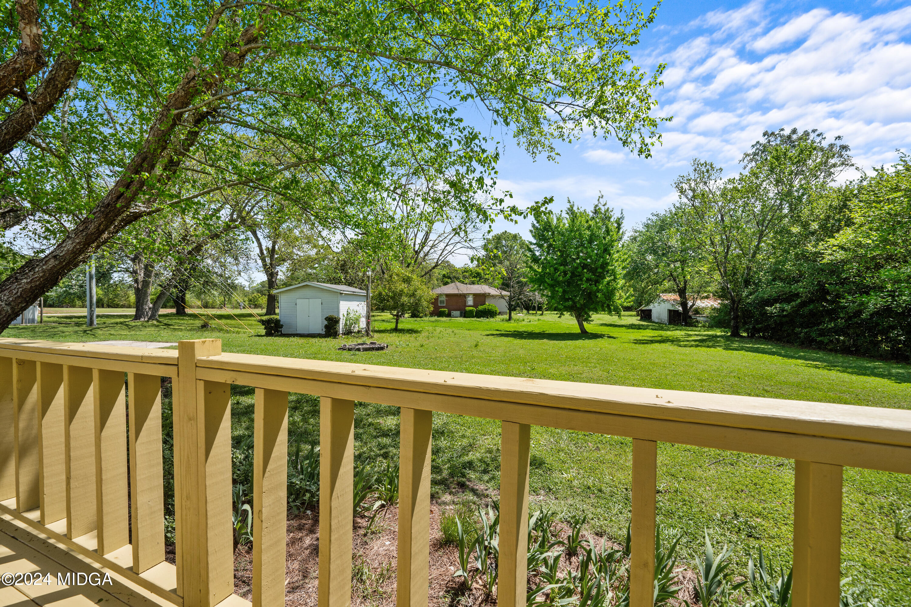 246 Langston Road Perry, GA 31069 - Photo 6 of 37 a balcony with trees in front of it