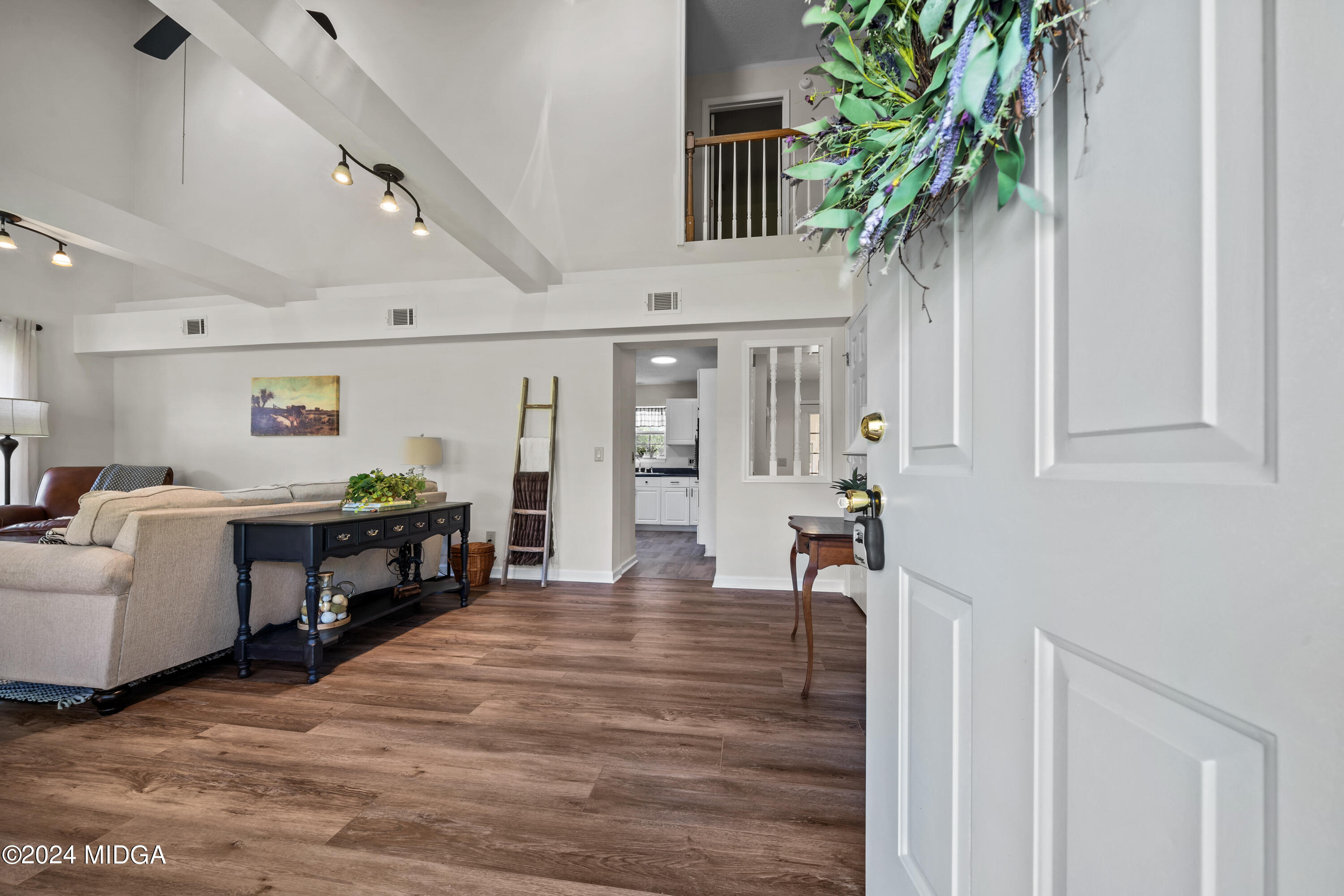246 Langston Road Perry, GA 31069 - Photo 8 of 37 a living room with furniture a potted plant and a kitchen view
