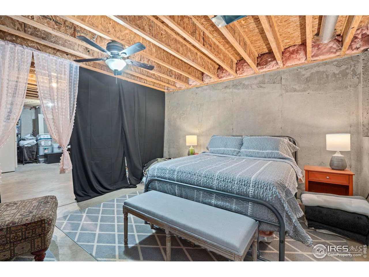 3224 Barbera Street Evans, CO 80634 - Photo 17 of 20 a bedroom with a bed a mirror and shower