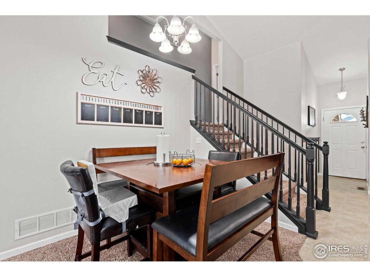 3224 Barbera Street Evans, CO 80634 - Photo 5 of 20 a dining room with wooden floor and a chandelier