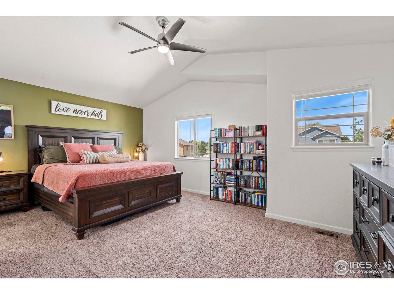 3224 Barbera Street Evans, CO 80634 - Photo 8 of 20 a bedroom with a bed a dresser and a book shelf