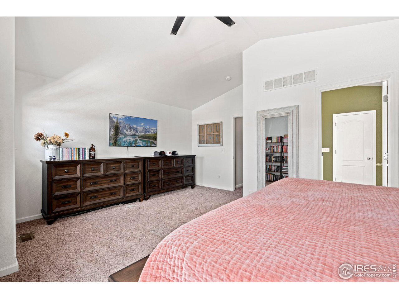 3224 Barbera Street Evans, CO 80634 - Photo 9 of 20 a large bedroom with a dresser and a chandelier