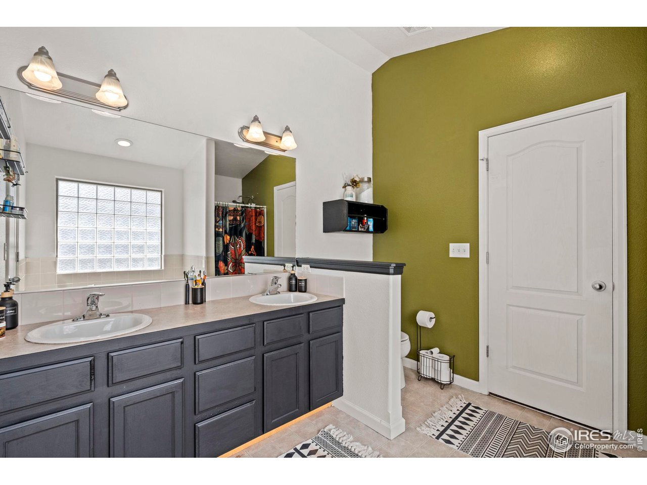3224 Barbera Street Evans, CO 80634 - Photo 10 of 20 a bathroom with a sink mirror and toilet