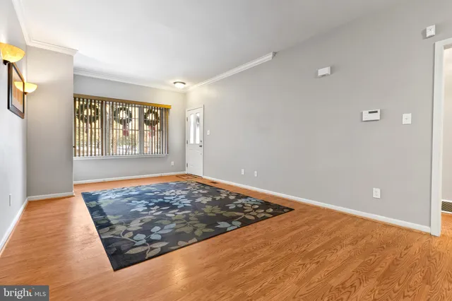 a view of a livingroom with wooden floor and window