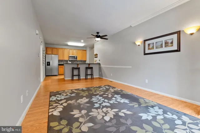 a large room with pool table and chairs