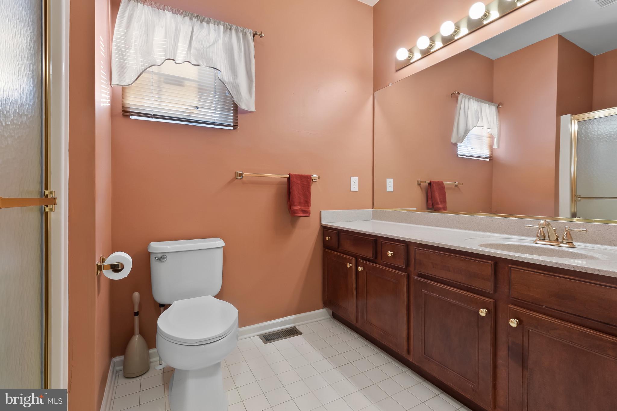 1 Osmond Way Delanco, NJ 08075 - Photo 17 of 26 a bathroom with a toilet a sink a mirror a vanity and shower