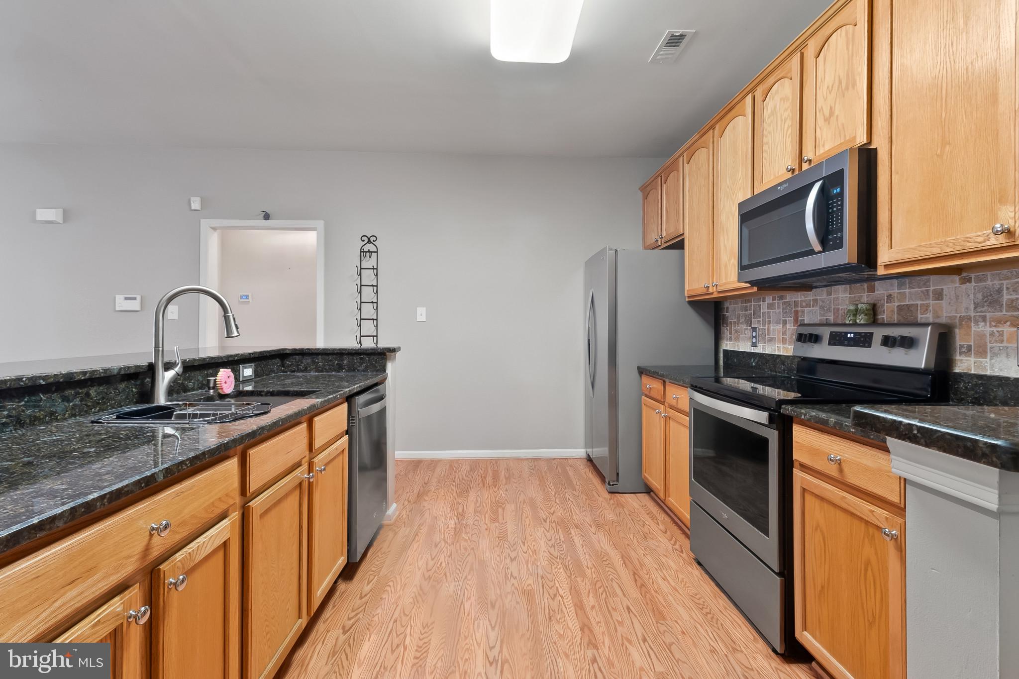 1 Osmond Way Delanco, NJ 08075 - Photo 8 of 26 a kitchen with stainless steel appliances granite countertop a sink stove and refrigerator