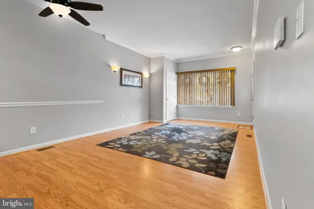 a view of a livingroom with wooden floor and window