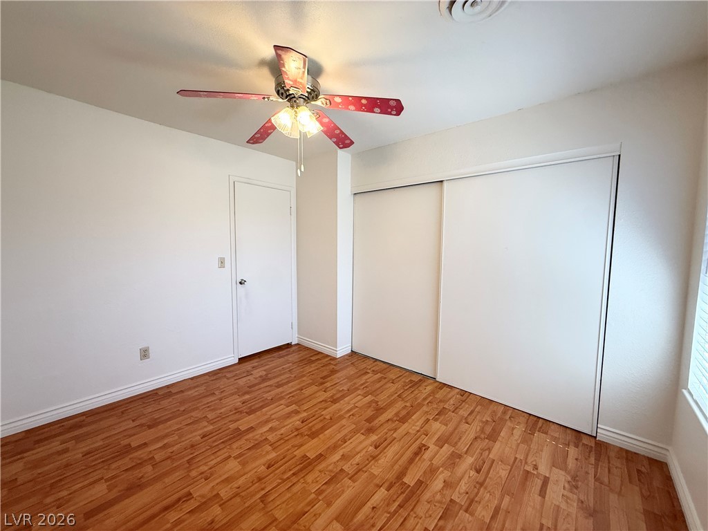 616 Greenway Road Henderson, NV 89002 - Photo 25 of 32 Bright and airy, this bedroom features rich laminate flooring and a spacious closet.