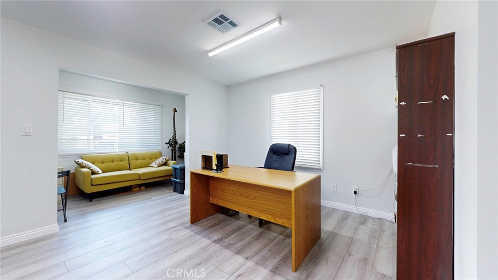 6851 Foothill Boulevard Tujunga, CA 91042 - Photo 18 of 50 a bedroom with furniture and a wooden floor