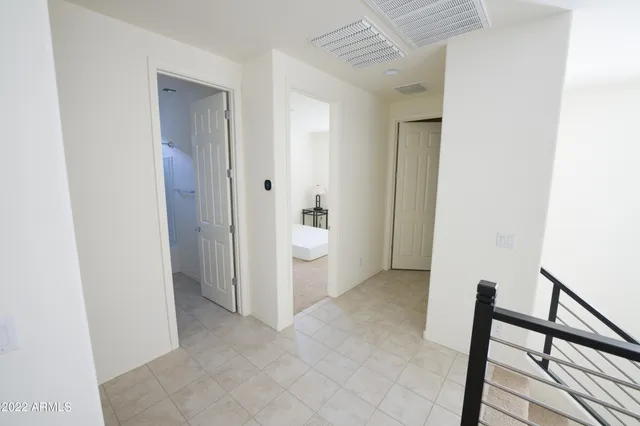 a view of a hallway with closet and utility room
