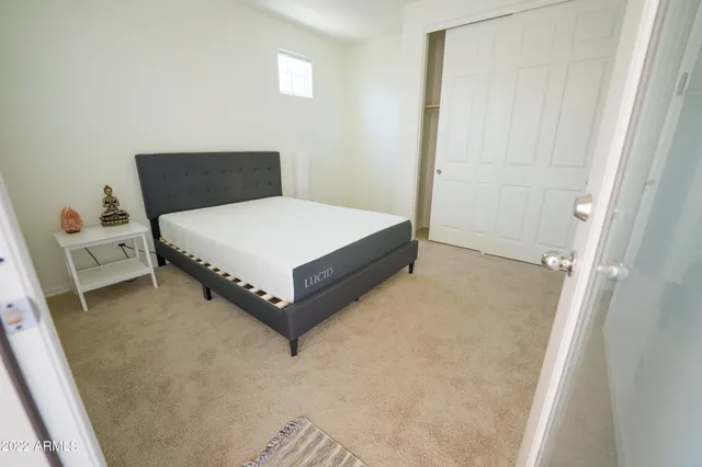 a bed sitting in a bedroom next to a window