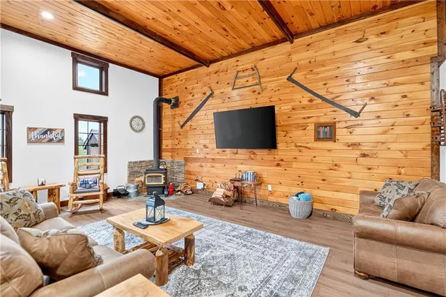 a living room with patio furniture and a flat screen tv