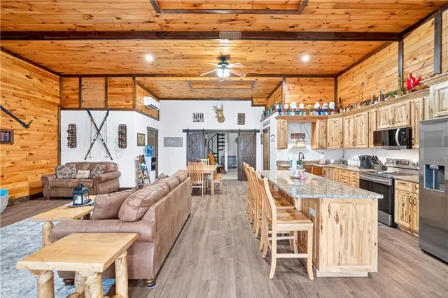 a view of a patio with couches chairs and wooden floor
