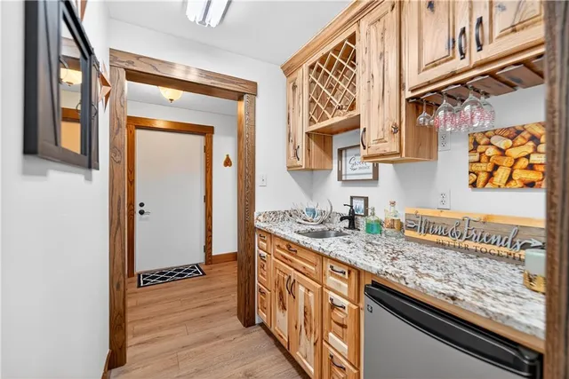 a kitchen with stainless steel appliances granite countertop a sink and a refrigerator