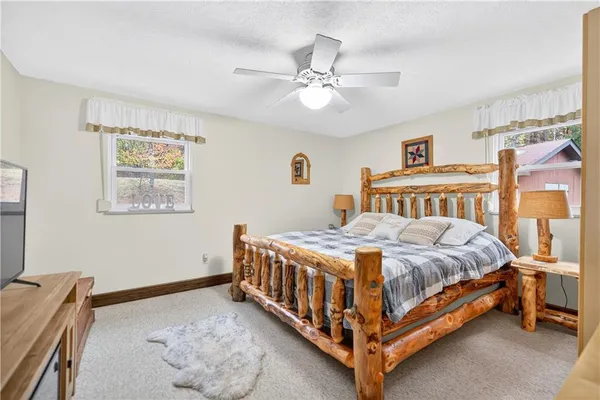 a bedroom with a bed and a chandelier