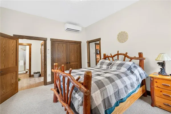 a bedroom with bed and a large mirror