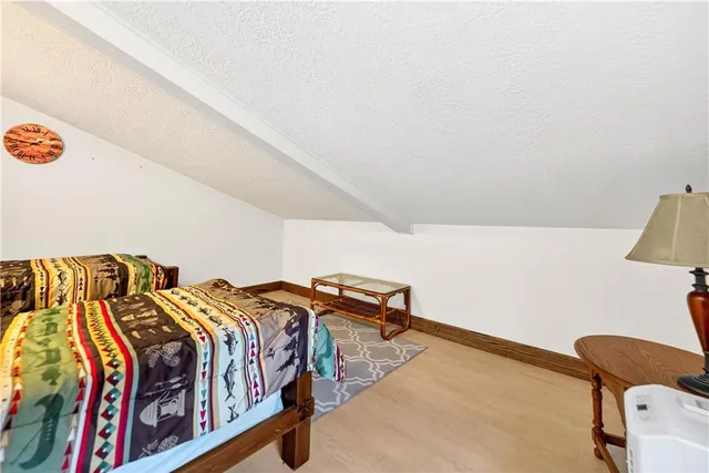 a bedroom with two beds and a couch