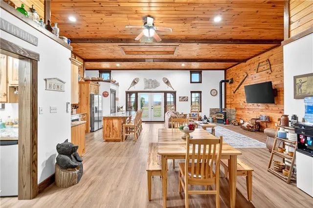 a view of a livingroom with furniture a flat screen tv and wooden floor