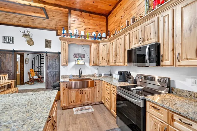 a kitchen with stainless steel appliances granite countertop a stove and a sink