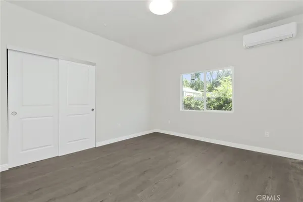 a bedroom with a bed and a potted plant