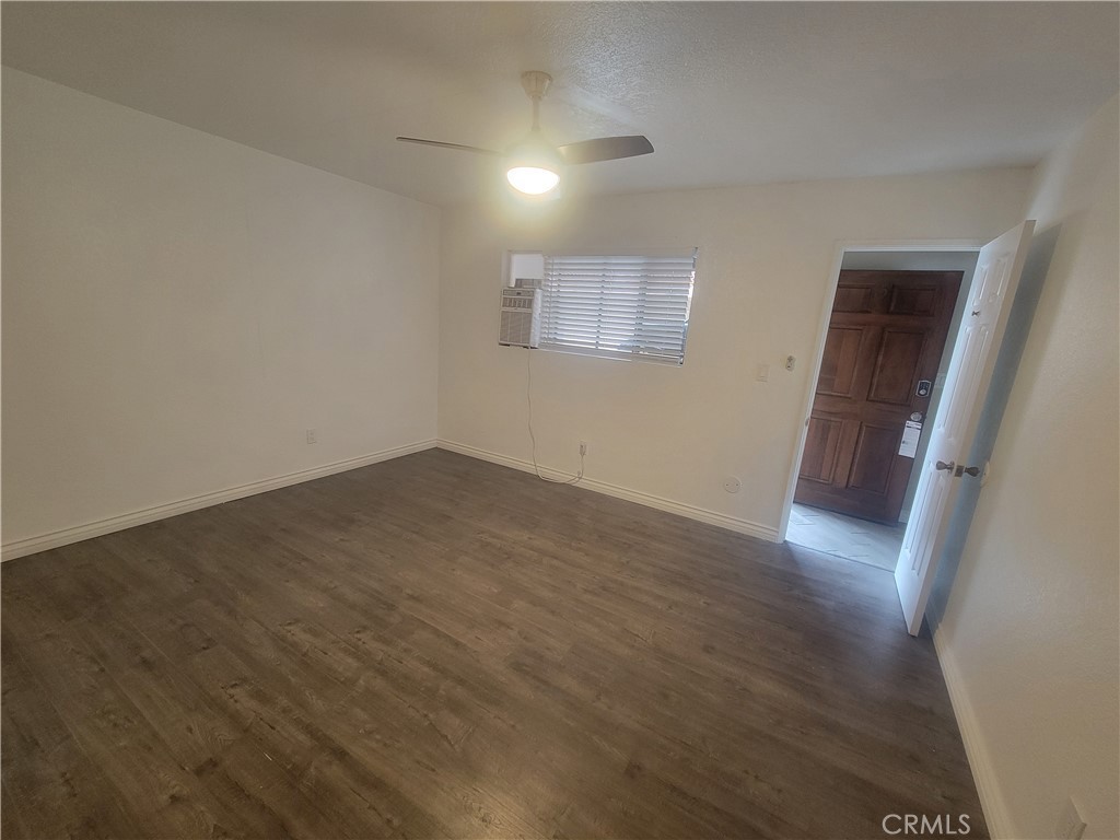 15005 Indiana Paramount, CA 90723 - Photo 4 of 7 an empty room with wooden floor and windows
