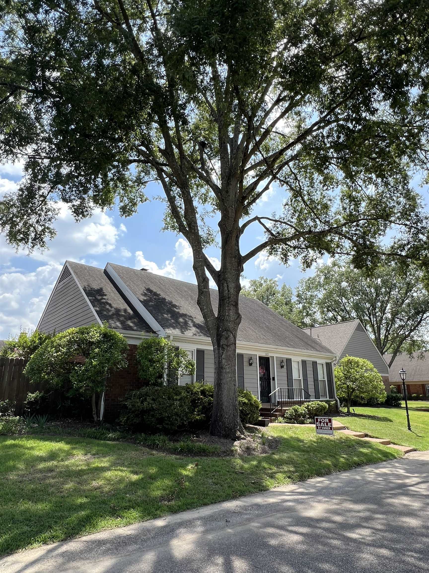 a front view of a house with a garden