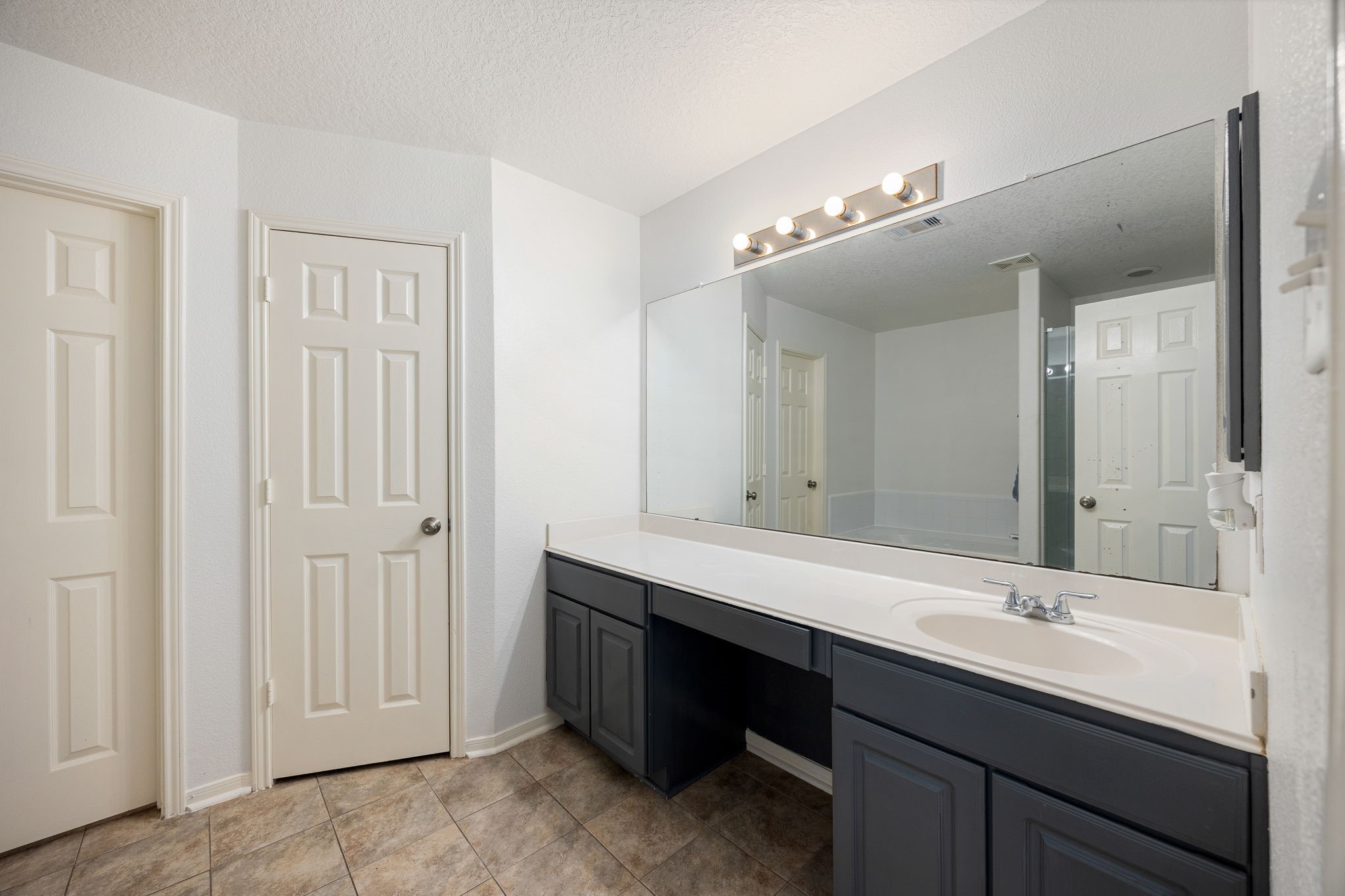 5038 Natchez Ridge Court Katy, TX 77449 - Photo 17 of 26 a bathroom with double vanity sinks and a mirror