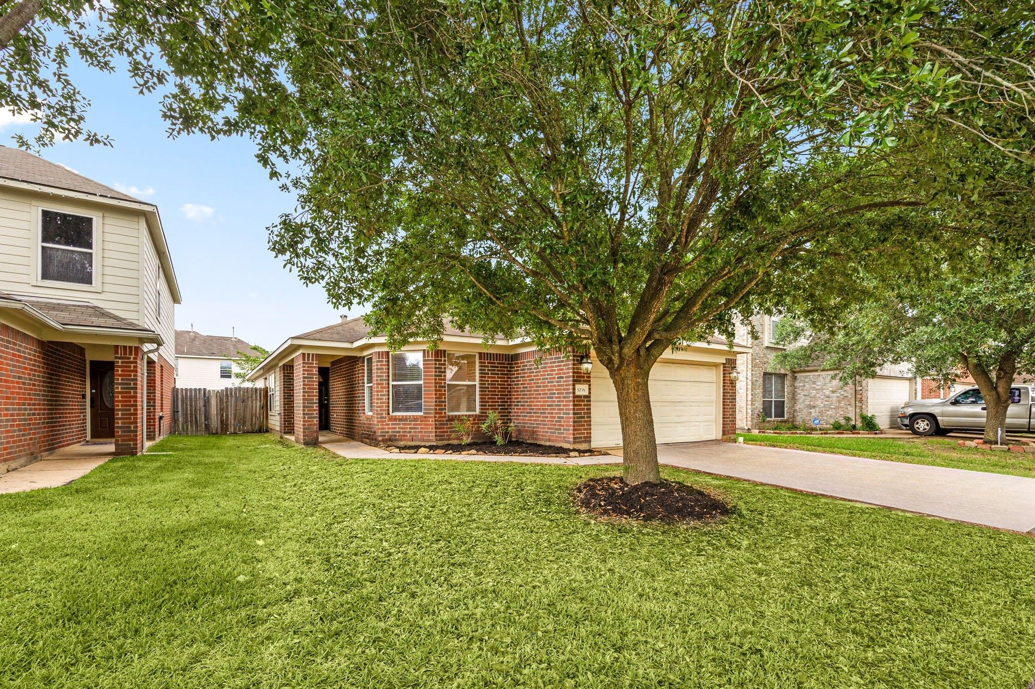 5038 Natchez Ridge Court Katy, TX 77449 - Photo 2 of 26 a front view of a house with a yard and trees