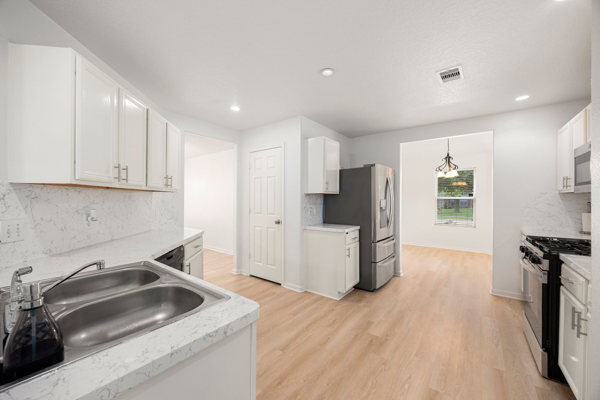 5038 Natchez Ridge Court Katy, TX 77449 - Photo 9 of 26 a kitchen that has a sink cabinets counter space and appliances