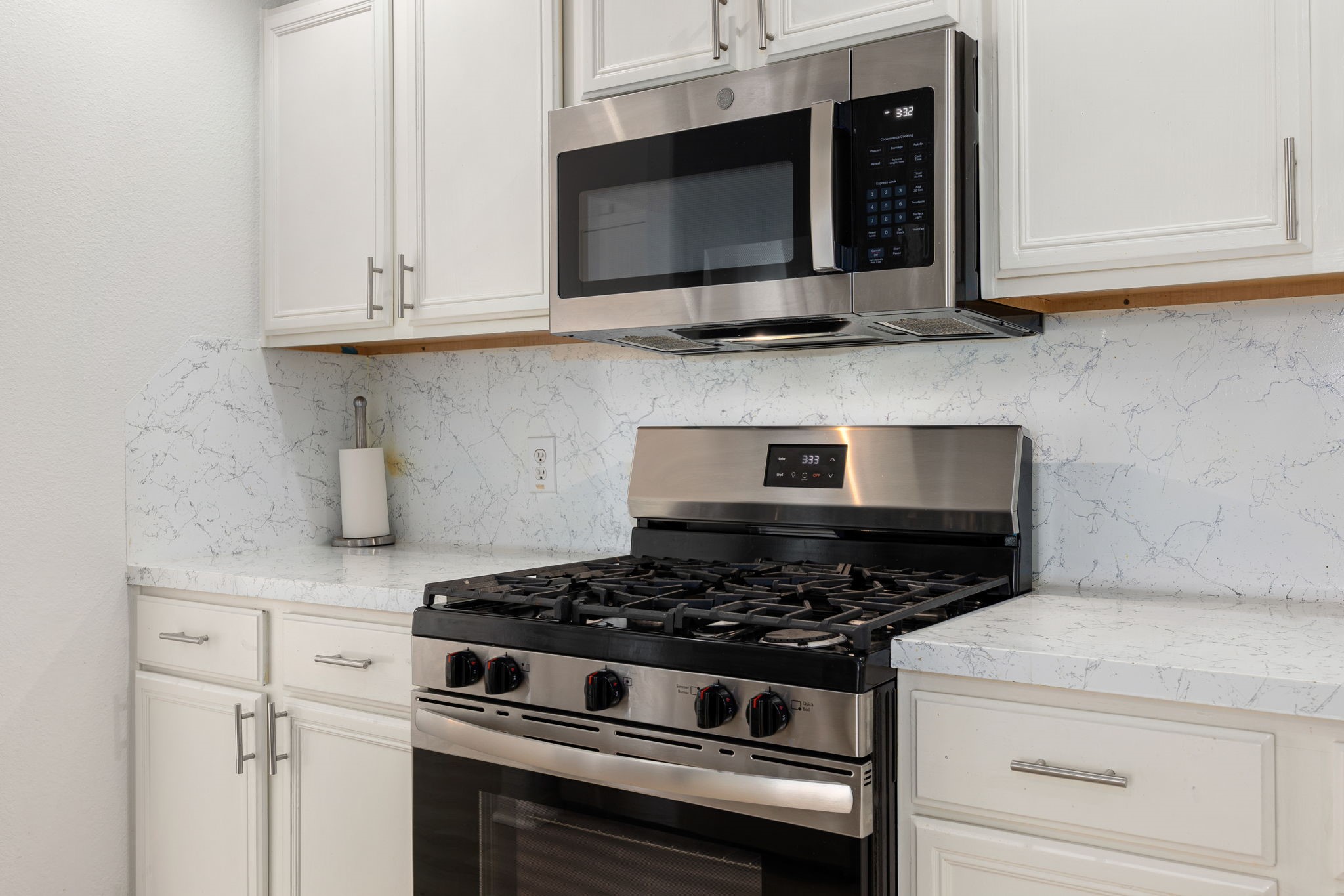 5038 Natchez Ridge Court Katy, TX 77449 - Photo 10 of 26 a kitchen with stainless steel appliances granite countertop white cabinets and stove