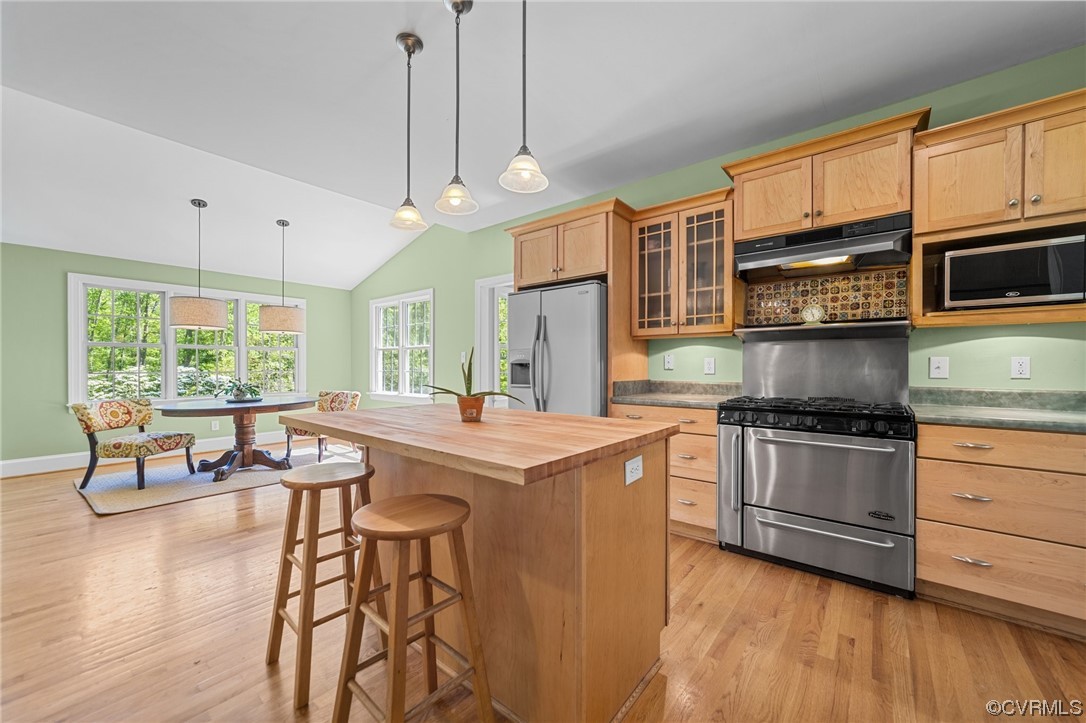 15163 Rice Road Beaverdam, VA 23015 - Photo 6 of 50 a kitchen with stainless steel appliances granite countertop a stove a sink dishwasher a microwave oven and a dining table with wooden floor