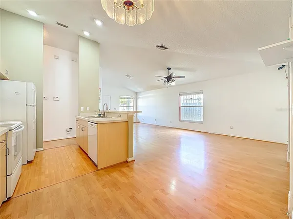 a kitchen with a stove a refrigerator and a sink