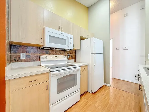 a kitchen with a refrigerator and a stove