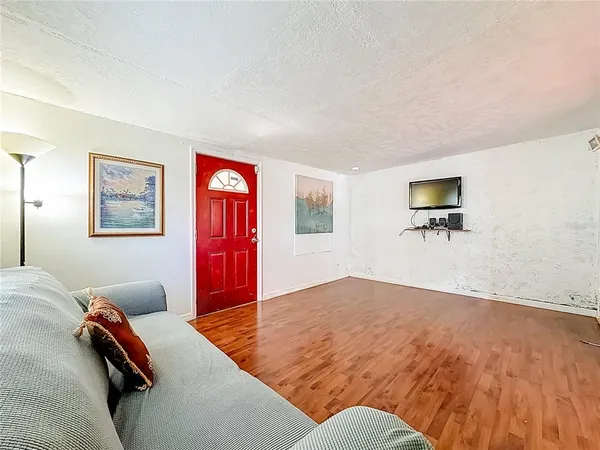 a view of empty room with wooden floor