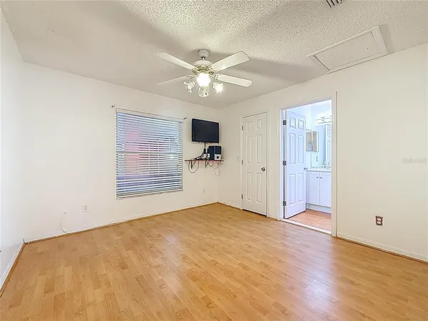 a bathroom with a toilet a sink a mirror a bathtub and vanity