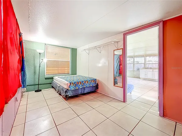 a view of a backyard with large trees and wooden fence