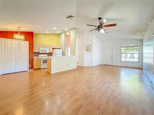 a view of a kitchen with a sink and a refrigerator