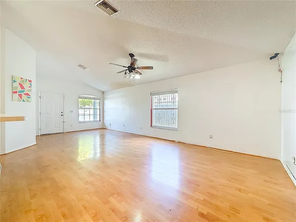 a kitchen with cabinets and wooden floor