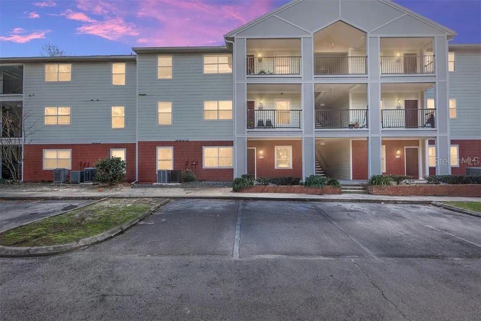 2360 Southwest Archer Road, Unit 704 Gainesville, FL 32608 - Photo 1 of 1 a front view of a building with a yard